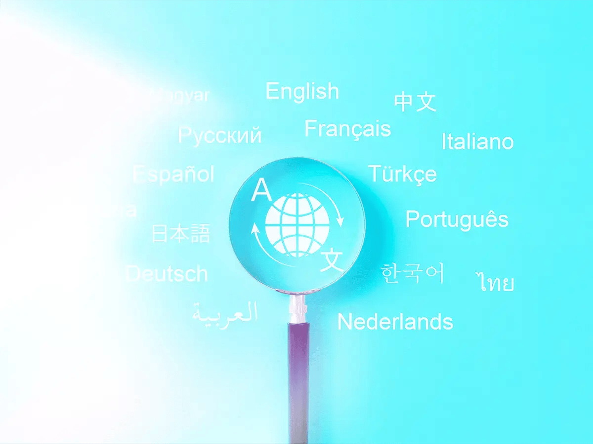 A magnifying glass highlights a globe with arrows, surrounded by the word language in various languages on a blue background