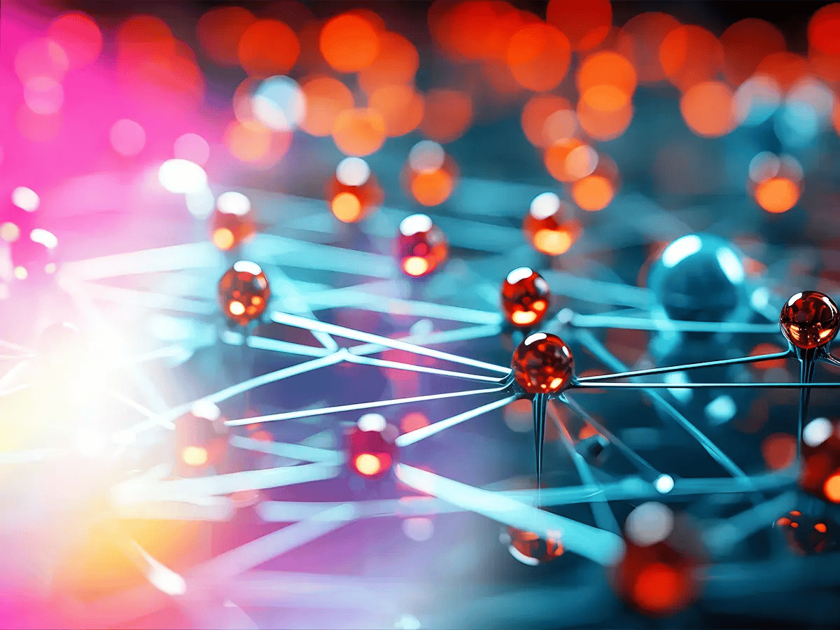 A network of reflective, shiny, red spheres connected by thin, glowing blue lines, against a blurred background of orange and blue circles