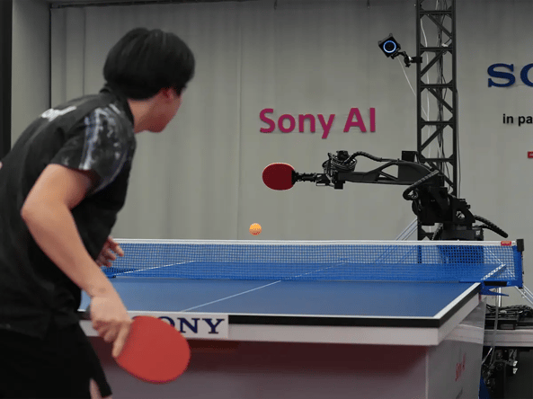 A person playing table tennis with a robotic arm labeled Sony AI.
