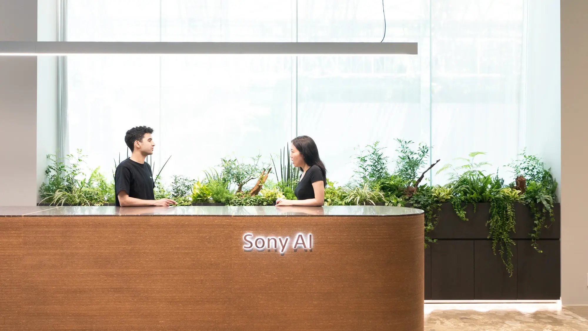 Two people standing at front lobby of Tokyo office
